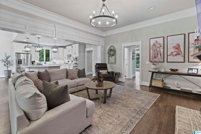 living room with crown molding, dark hardwood / wood-style floors, and a chandelier