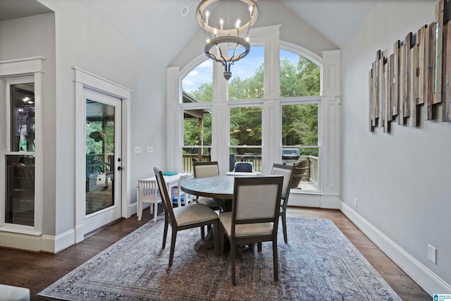 dining space with lofted ceiling, a chandelier, and dark hardwood / wood-style floors