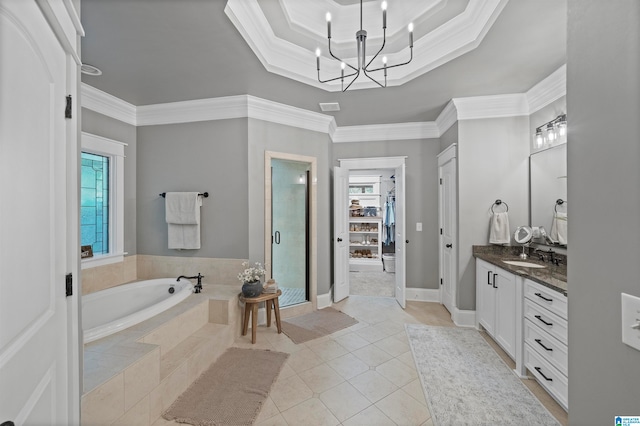 bathroom featuring vanity, a notable chandelier, tile patterned floors, tiled bath, and crown molding