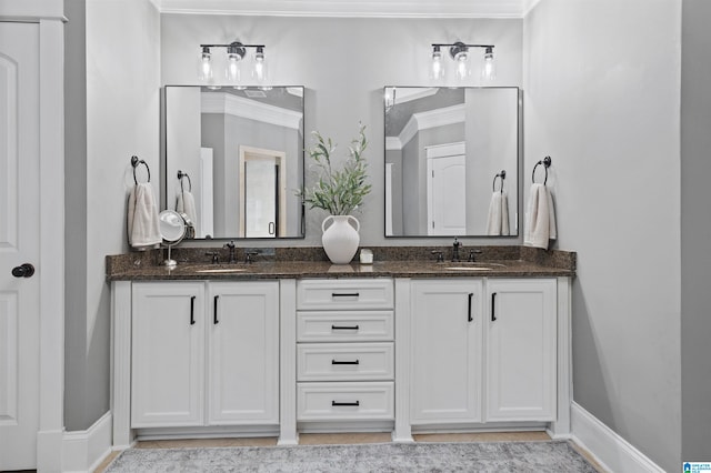 bathroom with ornamental molding and vanity