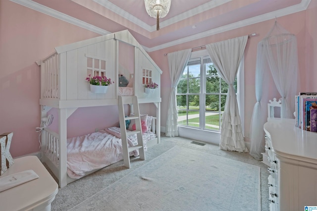 bedroom featuring a raised ceiling, carpet flooring, and crown molding