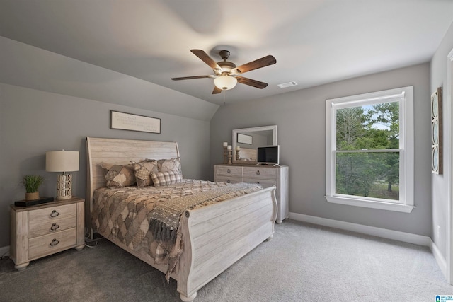 bedroom featuring ceiling fan, lofted ceiling, and dark colored carpet