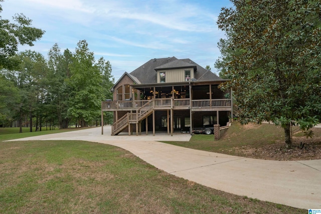 back of property with a lawn and a wooden deck