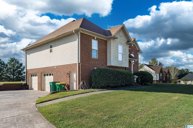 view of side of home with a garage and a yard