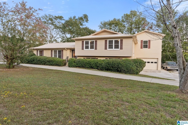 split level home featuring an attached garage, a front yard, and concrete driveway
