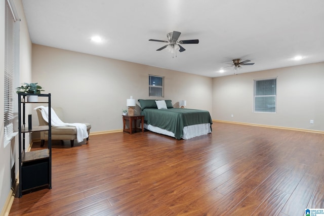 bedroom with dark hardwood / wood-style flooring and ceiling fan