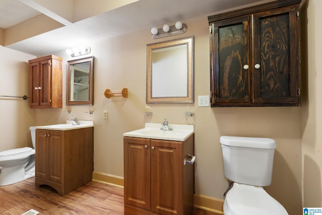 bathroom with vanity, hardwood / wood-style floors, and toilet