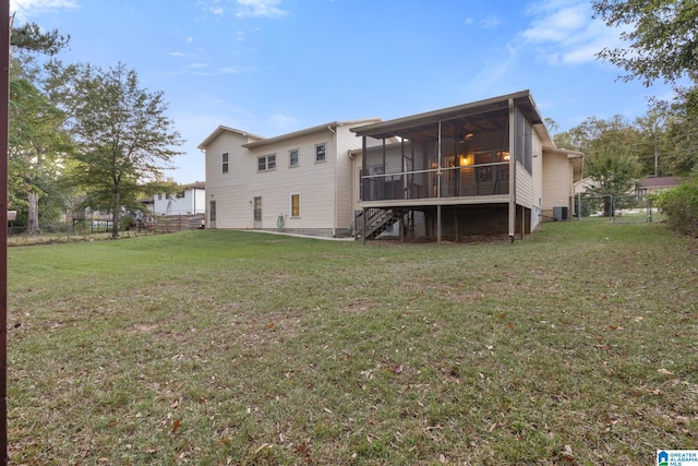 back of house featuring a lawn, central AC unit, and a sunroom