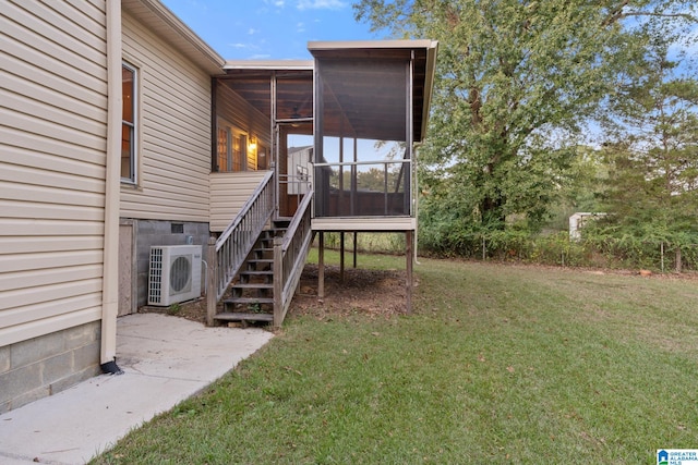 view of yard with ac unit and a sunroom