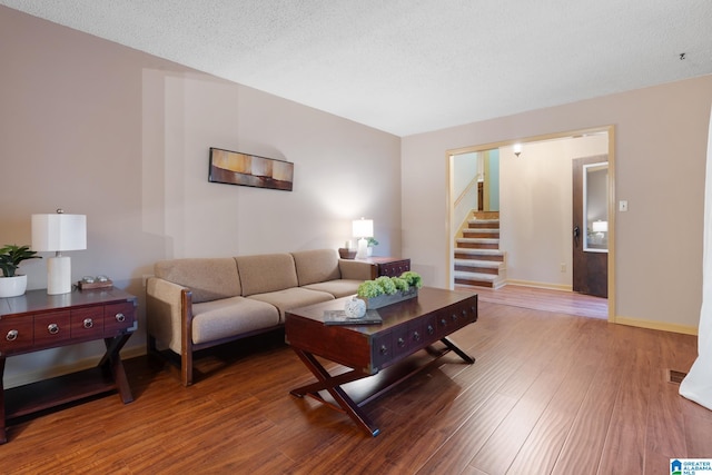 living room featuring hardwood / wood-style floors and a textured ceiling