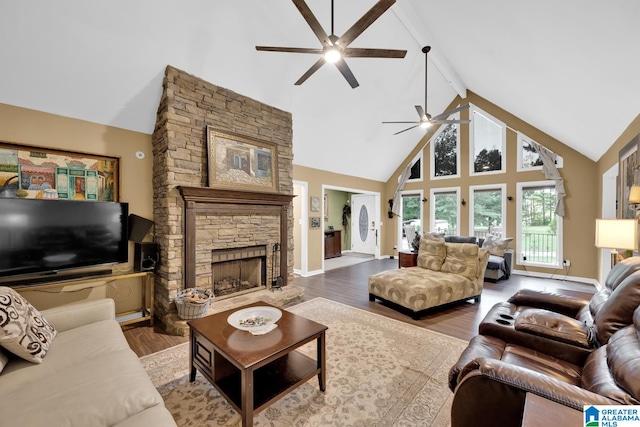 living room featuring ceiling fan, hardwood / wood-style flooring, high vaulted ceiling, beamed ceiling, and a fireplace