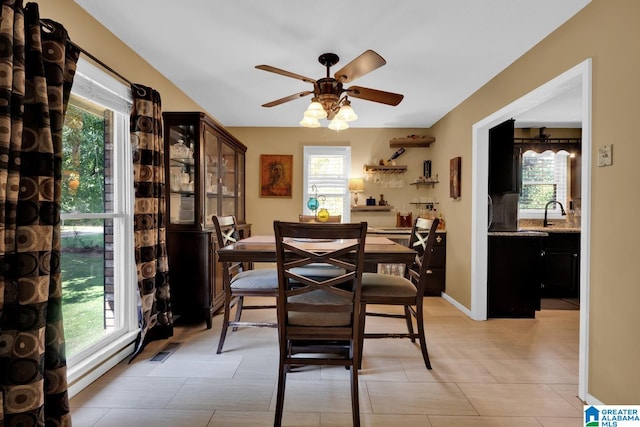 dining area featuring ceiling fan, plenty of natural light, and light tile patterned flooring