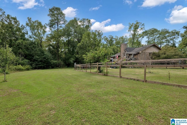 view of yard with a rural view