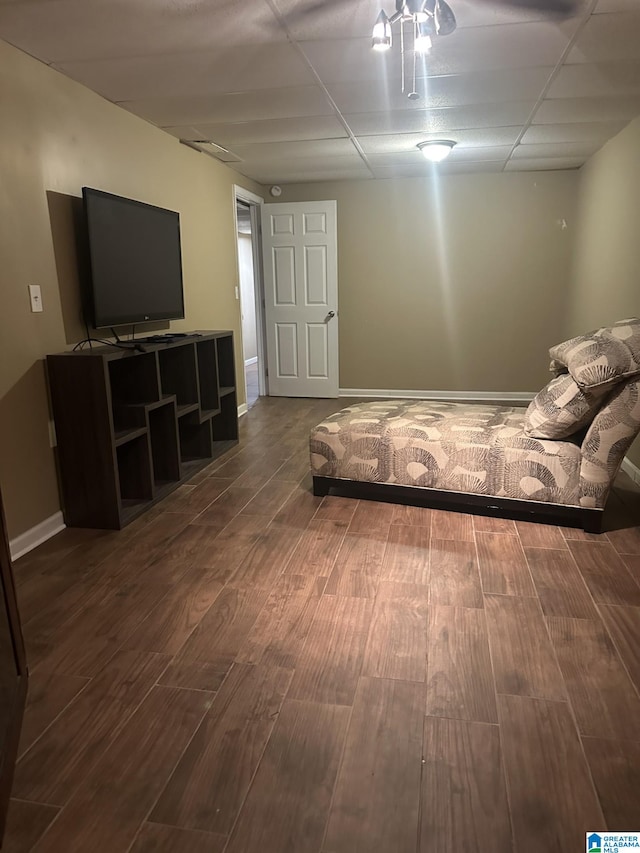 unfurnished bedroom featuring hardwood / wood-style floors and a drop ceiling