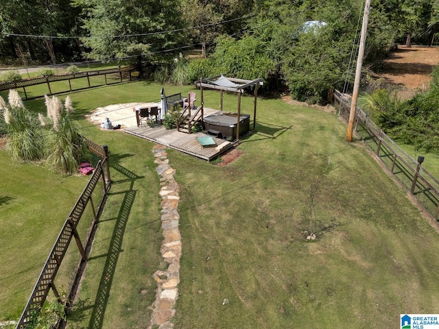 view of yard featuring a rural view, a hot tub, and a deck