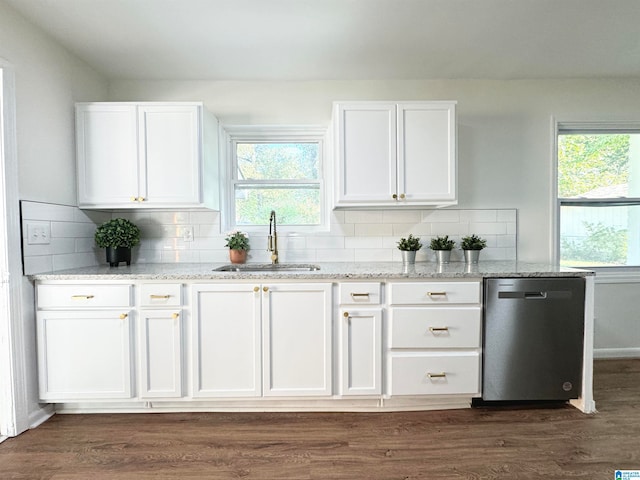 kitchen with a wealth of natural light, dishwasher, sink, and white cabinets