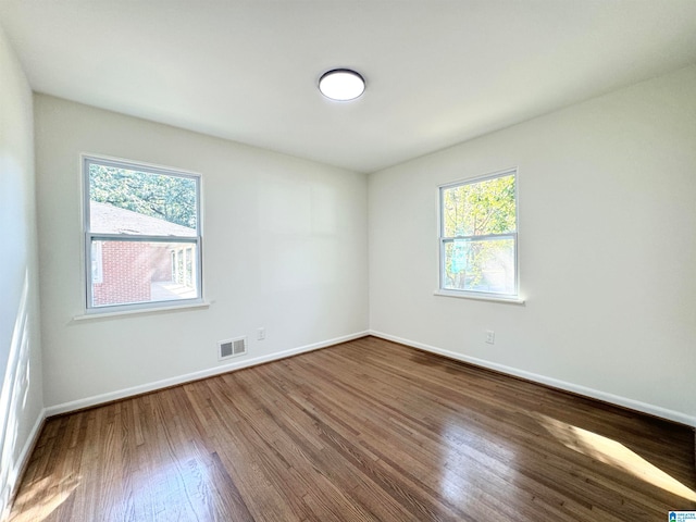 empty room featuring hardwood / wood-style flooring and a wealth of natural light