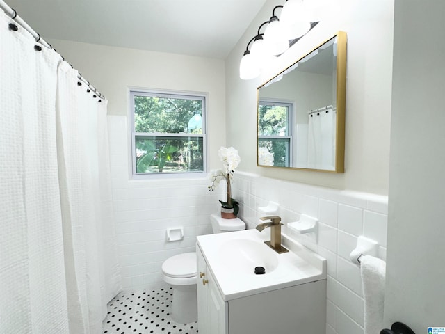 bathroom featuring tile walls, tile patterned floors, vanity, and toilet