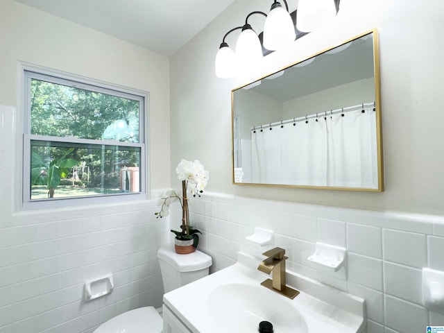 bathroom featuring tile walls, vanity, toilet, and a shower with shower curtain