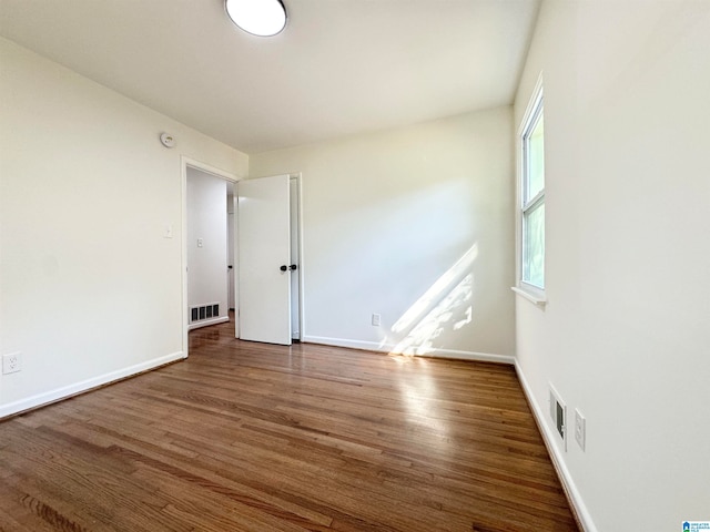 spare room with dark wood-type flooring