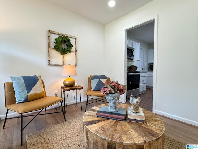 sitting room with hardwood / wood-style floors