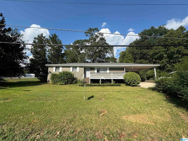 view of front facade featuring a front lawn and a carport