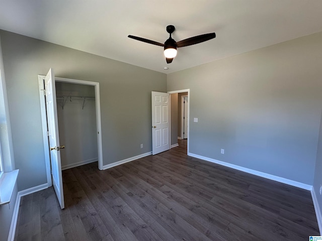 unfurnished bedroom featuring ceiling fan, a closet, and dark wood-type flooring