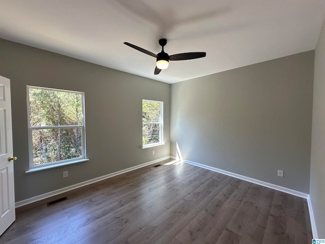 empty room featuring ceiling fan and dark hardwood / wood-style floors