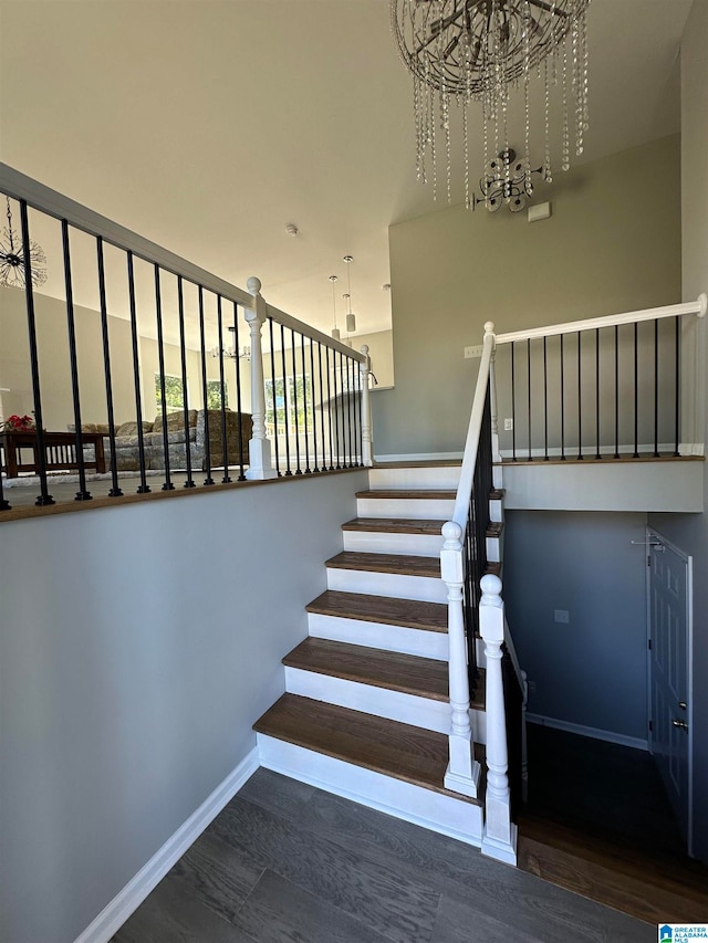 stairway featuring a notable chandelier and hardwood / wood-style floors