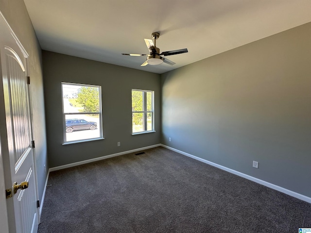 carpeted empty room featuring ceiling fan