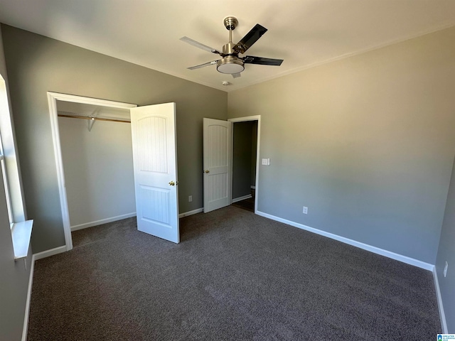 unfurnished bedroom with a closet, dark colored carpet, and ceiling fan