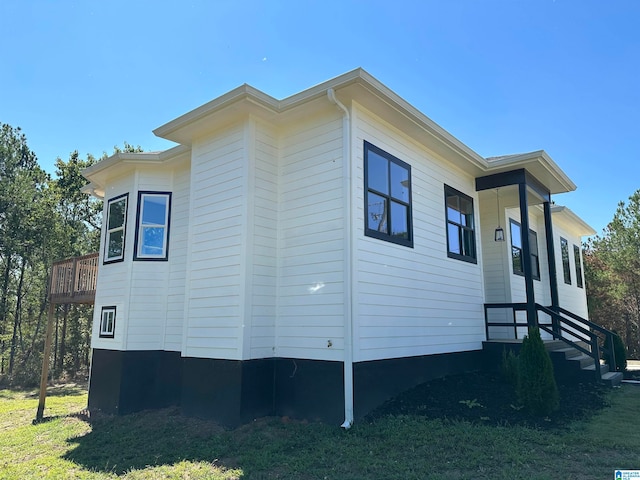 view of side of home featuring a lawn