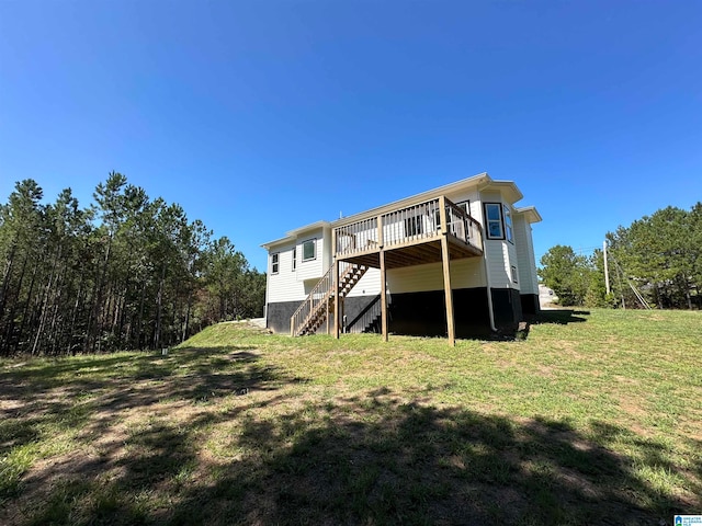 rear view of property with a lawn and a deck