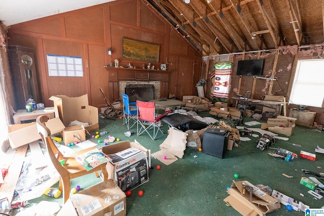 misc room with lofted ceiling and wood walls