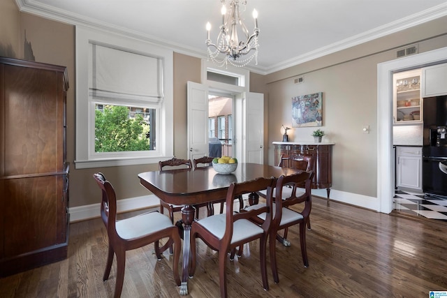 dining room featuring an inviting chandelier, crown molding, and dark wood-type flooring