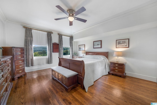 bedroom with ceiling fan, dark hardwood / wood-style floors, and crown molding