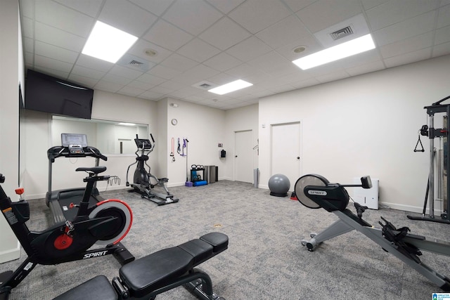 workout area with carpet flooring and a paneled ceiling