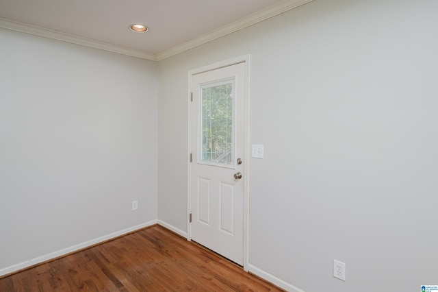 doorway to outside featuring wood-type flooring and crown molding