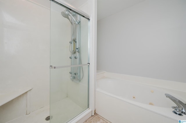 bathroom featuring plus walk in shower and tile patterned floors