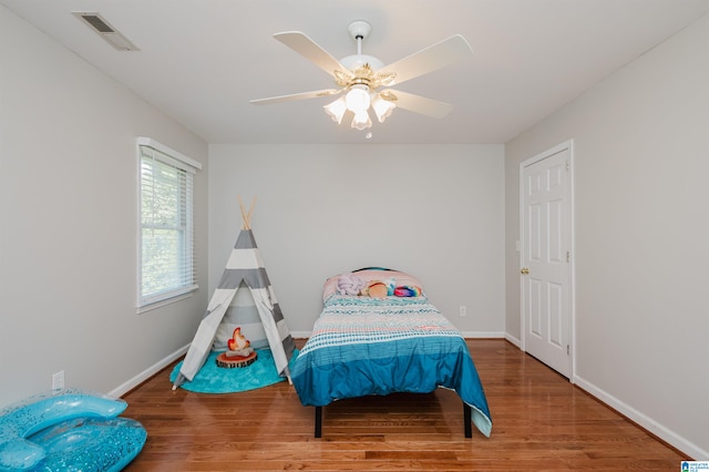 bedroom featuring ceiling fan and hardwood / wood-style flooring