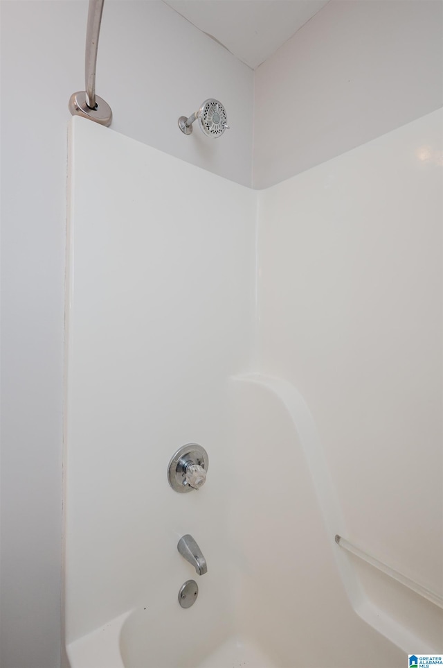 room details featuring shower / washtub combination