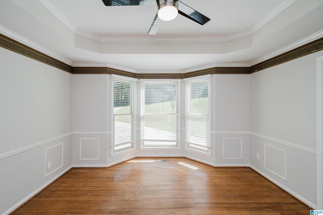 unfurnished room with ceiling fan, crown molding, and hardwood / wood-style floors