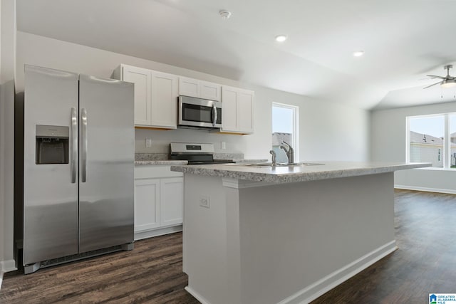 kitchen with white cabinetry, dark wood-style flooring, a sink, an island with sink, and appliances with stainless steel finishes