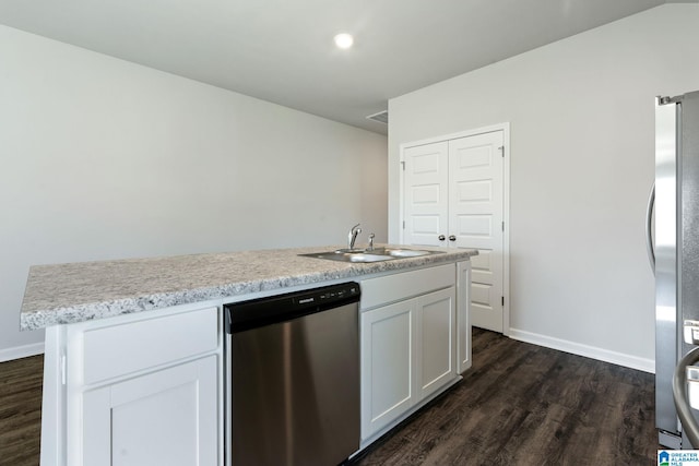 kitchen featuring dark wood-style floors, a sink, light countertops, and appliances with stainless steel finishes