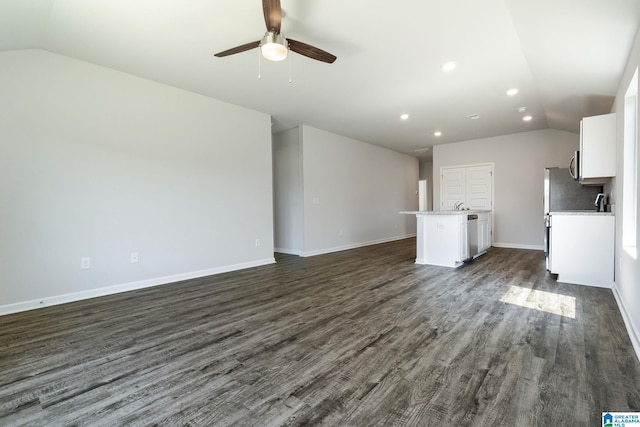 unfurnished living room with baseboards, lofted ceiling, ceiling fan, and dark wood-style floors