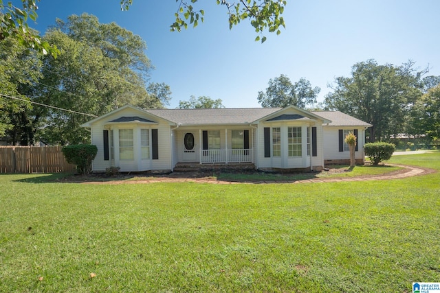 ranch-style house featuring a front lawn and a porch