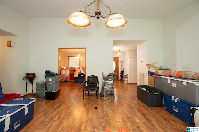 dining space with dark hardwood / wood-style floors and an inviting chandelier