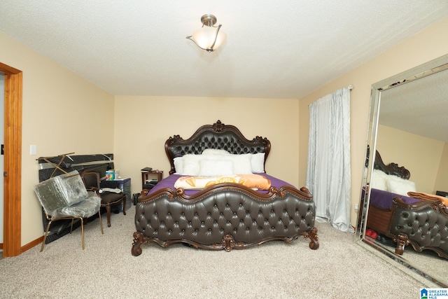 carpeted bedroom featuring a textured ceiling