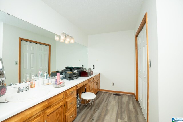 bathroom with hardwood / wood-style flooring and vanity