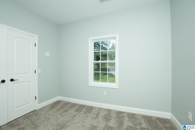 unfurnished room featuring carpet